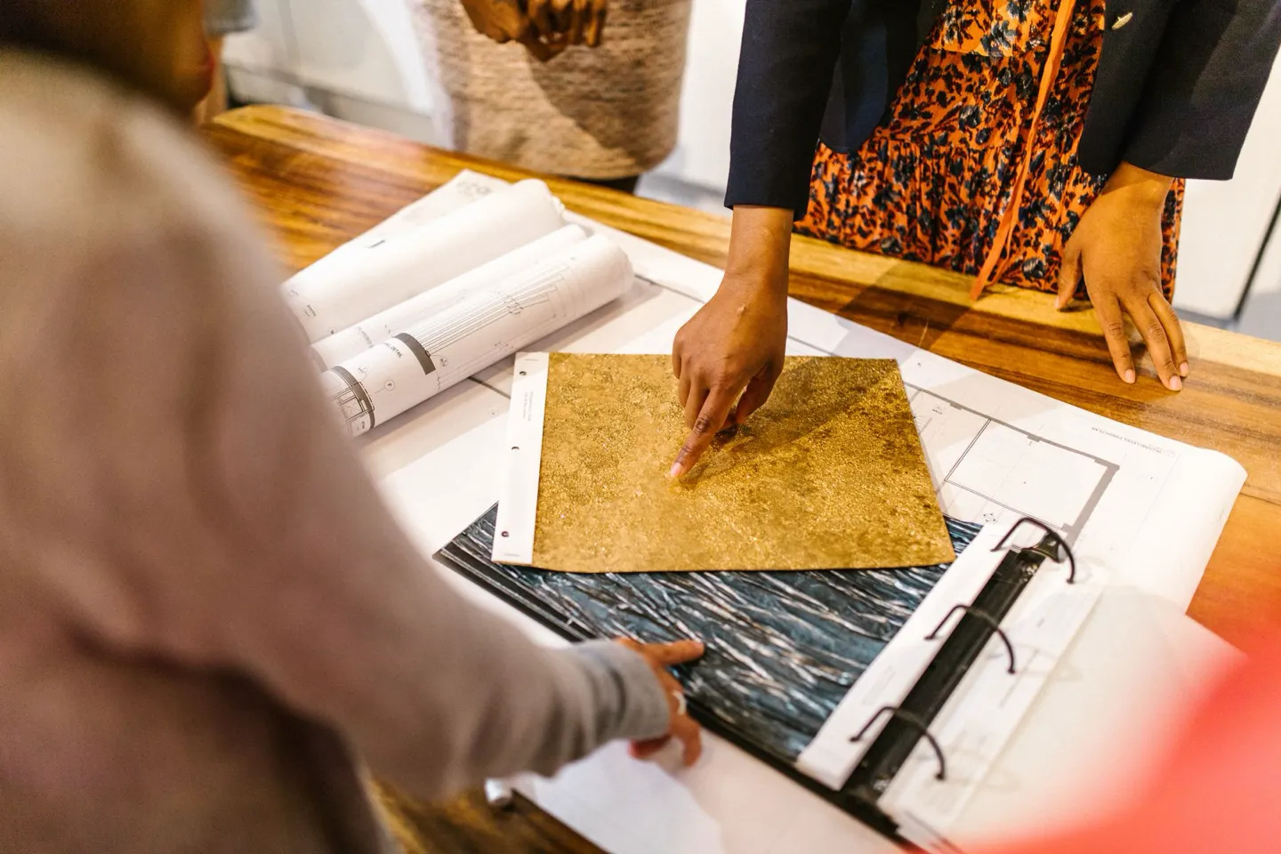 Interior design consultation over plans and material samples