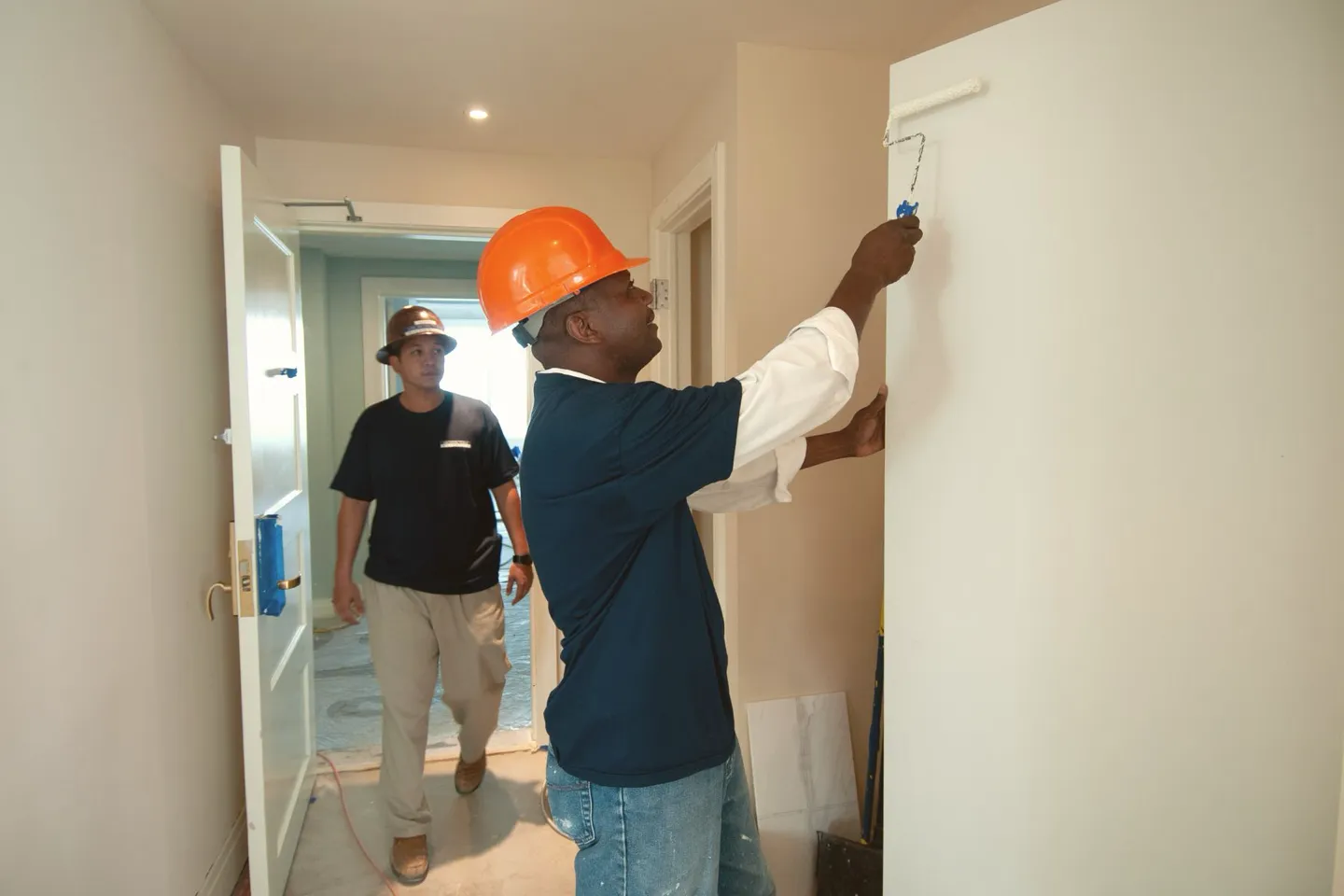 Construction team painting an interior wall